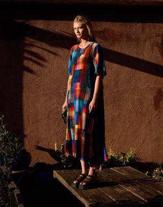 Model wearing the ELK Dress Byde in Ekko Print, available at Pink Poppies, colourful abstract midi dress with relaxed silhouette.